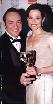 Kevin Spacey with Sigourney Weaver (and her award) at the 1998 BAFTA Awards